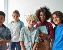 Group of students from different cultural backgrounds smiling together in a UAE classroom